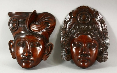 TWO INDONESIAN CARVED HARDWOOD MASKS of a male and