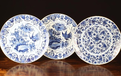 Three 18th Century Blue & White Delft Chargers: A pair painted with stork and flowers to the centre