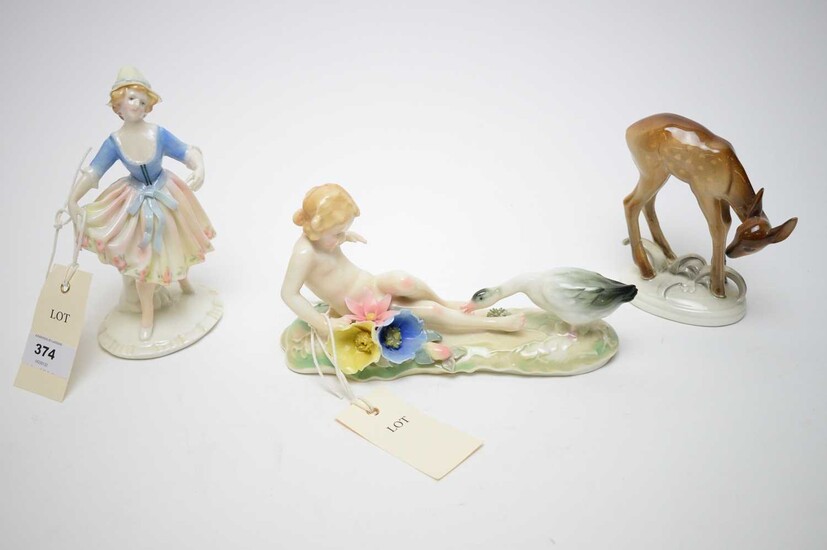 Three decorative ceramic figures.