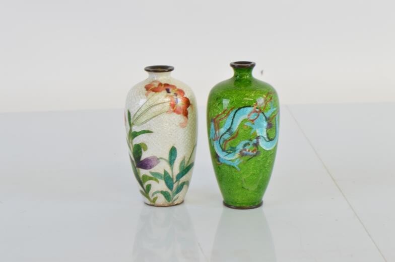Two Asian white metal and enamel ovoid vases, the...