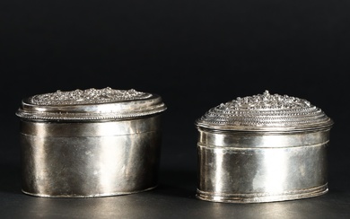 Two large oval Burmese lidded tins in silver. Start of the 1900s.