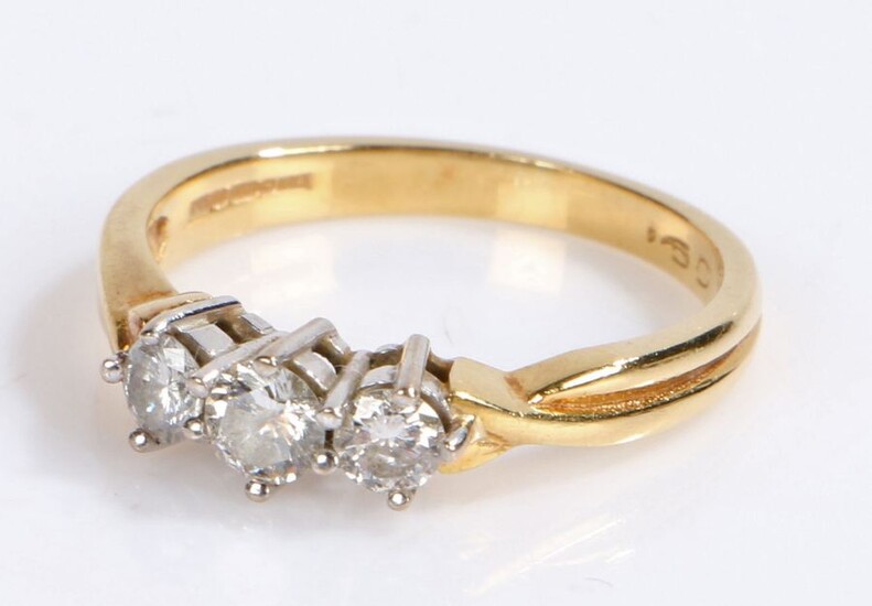 18 carat gold diamond set ring, with three round cut diamonds to the head, 3.7 grams, ring size O