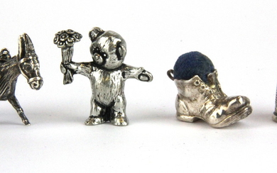 A 925 silver model of a donkey together with a .960 silver figure of a teddy bear, a hallmark silver boot pin cushion and a hallmarked silv