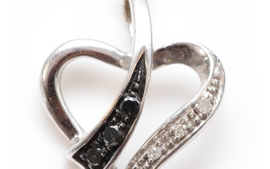 A 9ct white gold black and white diamond heart pendant, chai...