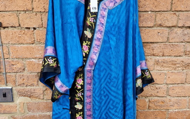 A CHINESE BLUE SILK ROBE EDGED IN PURPLE AND BLACK FLORAL EMBROIDERED BANDS