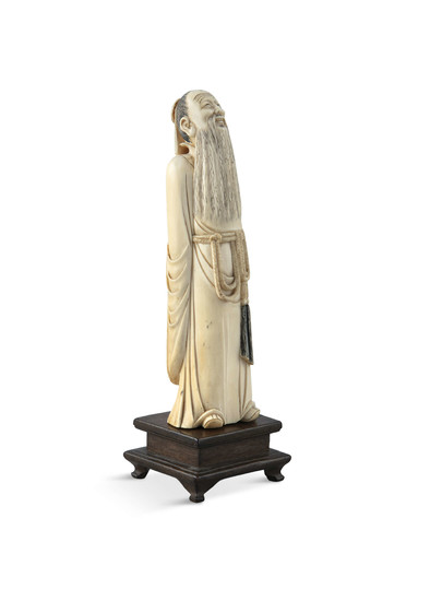 A CHINESE CARVED IVORY FIGURE...