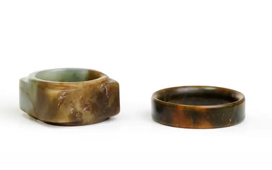 A Chinese archaistic celadon and russet jade cong and a bangle 20th...