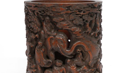 A Chinese bamboo brush pot richly carved with Buddhist deities. Qing 19th...