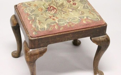 A GEORGIAN STOOL with needlework top on cabriole legs