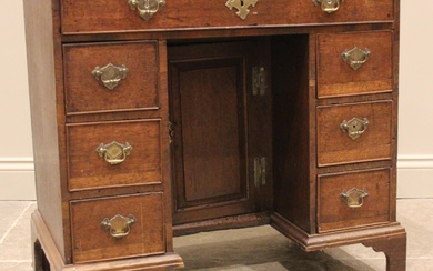 A George III oak kneehole desk, the rectangular moulded top ...
