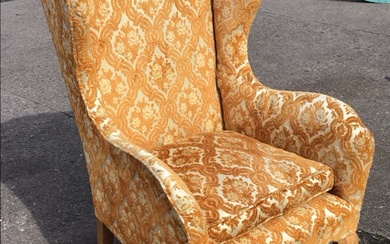 A Georgian style wing armchair with loose cushion and rounded...