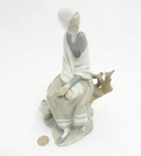 A Lladro 'New Shepherdess' figurine of a girl sat