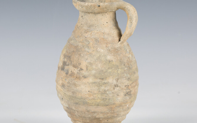 A Roman greyware vessel of ribbed ovoid form, the side with single loop handle, height 21cm.