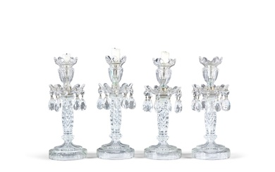 A SET OF FOUR CUT AND MOULDED GLASS LUSTRE CANDLESTICKS, 20T...