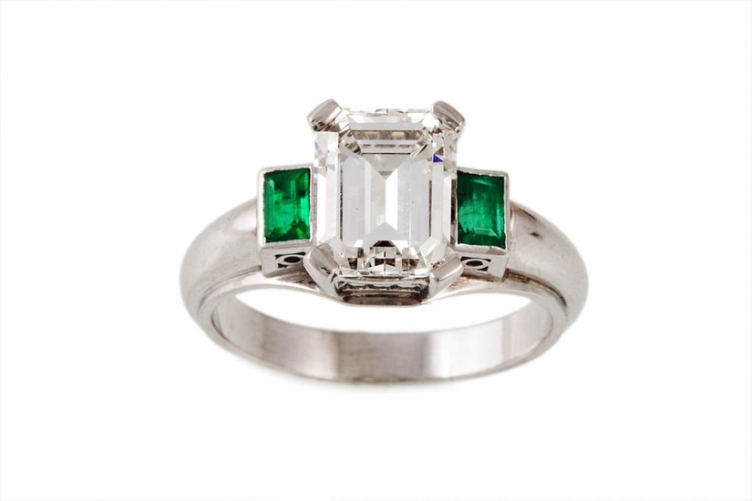 A SOLITAIRE DIAMOND RING, the emerald cut centre stone estim...