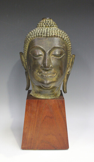 A Thai bronze Buddha head, probably 19th century, cast with eyes closed and modelled with tightly cu