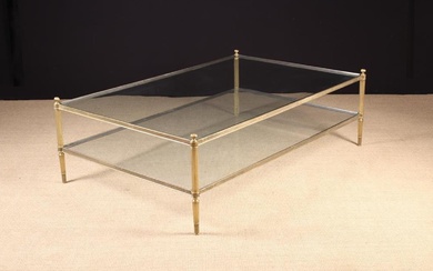 A Two-tier Glass Rectangular Coffee Table on gilt brass stop-fluted legs surmounted by wrythen finia