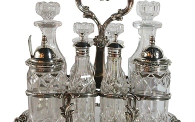 A Victorian silver & glass cruet set. 8 cruets upon a silver...