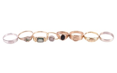 A collection of eight assorted rings, comprising a 9ct gold buckle ring, ring size N 1/2, an unmarke