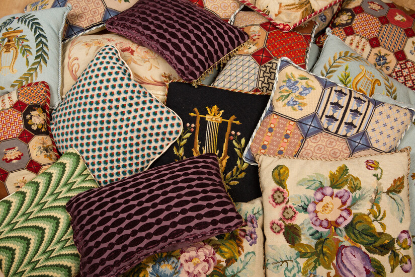 A collection of various needlework cushions