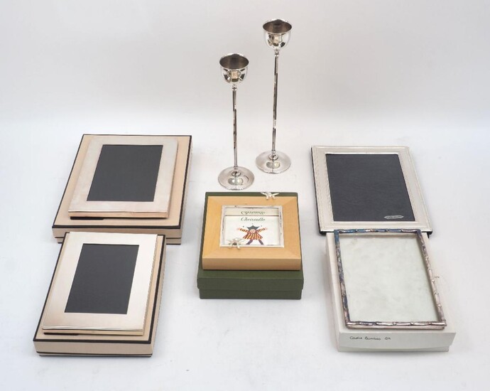 A group of five silver plated photo frames, including: two cased Links examples and one Christofle example; together with a pair of Italian silver plated candlesticks, designed with thin hexagonal stems to circular feet and rounded capitals, one...