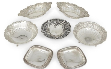 A group of silver comprising: a pair of Edwardian silver navette-shaped bonbon dishes, Birmingham, 1901, George Nathan & Ridley Hayes, with pierced and repousse sides, 20.8cm long; a pair of square bonbon dishes with gadrooned borders, stamped...