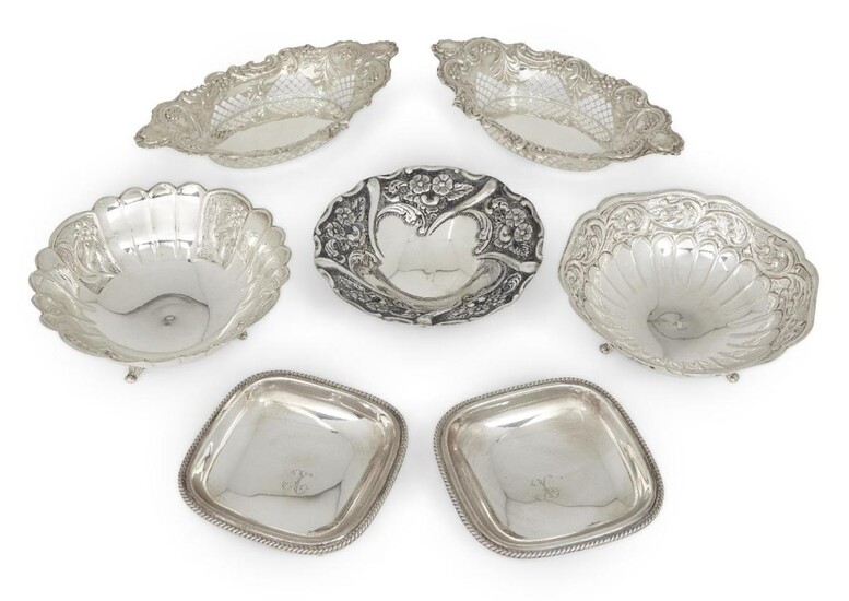 A group of silver comprising: a pair of Edwardian silver navette-shaped bonbon dishes, Birmingham, 1901, George Nathan & Ridley Hayes, with pierced and repousse sides, 20.8cm long; a pair of square bonbon dishes with gadrooned borders, stamped...