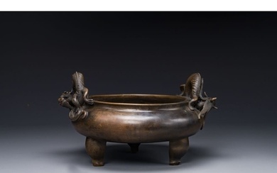 A large Chinese bronze tripod censer with 'chilong' handles,...