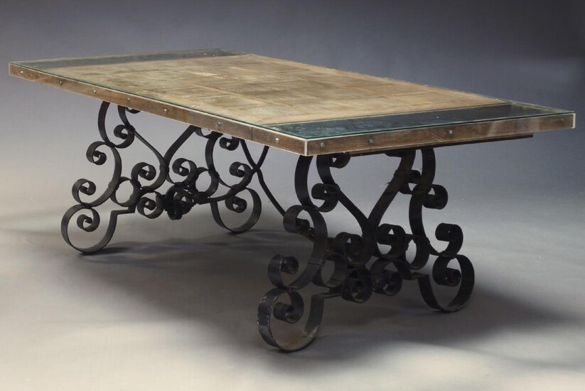 A large French wrought iron garden table, early 20th Century, with rectangular oak parquetry top, on scroll work wrought iron supports, 75cm high, 236cm wide, 101cm deep