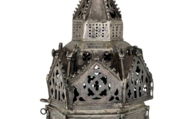 A large metal censer, of hexagonal form with a stepped, tapering turret to globular ringed finial, the crocketed triangular central panels pierced with quatrefoil and other motifs, this section detachable from hexagonal footed lower section...