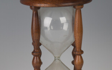 A late 20th century mahogany framed hour glass, height 26cm.