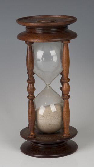 A late 20th century mahogany framed hour glass, height 26cm.