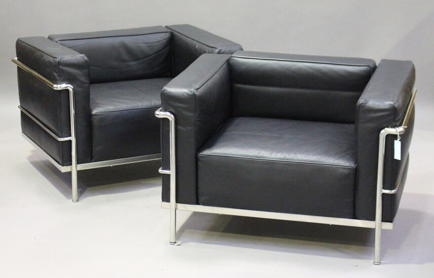 A pair of modern LC2 style armchairs, after a design by Le Corbusier, the black leather cushions sup