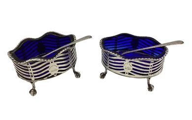 A pair of oval sterling silver salts with blue...
