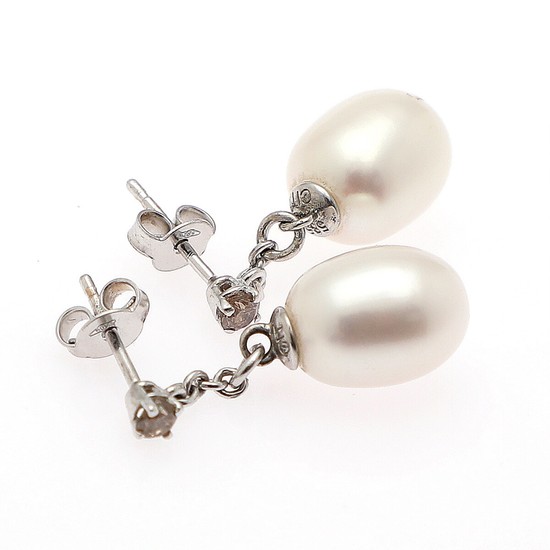 A pair of pearl and diamond ear pendants each set with a cultured fresh water pearl and a brilliant-cut diamond, mounted in 14k white gold. (2)
