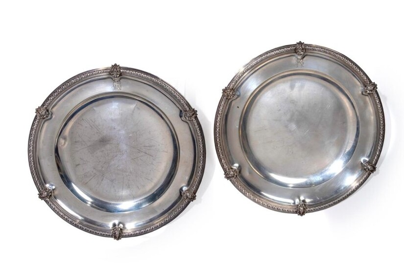 A pair of round silver dishes.