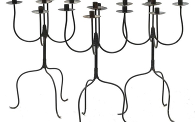 A set of three steel five-light candelabra
