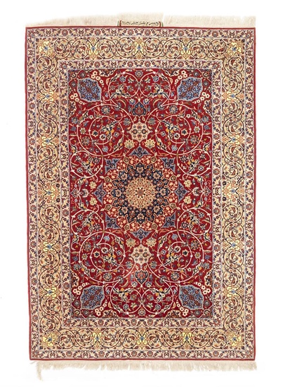 A signed Isfahan rug, Persia. An elegant and detailed medallion design on...