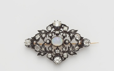 A silver 18k gold diamond and opal openwork brooch.