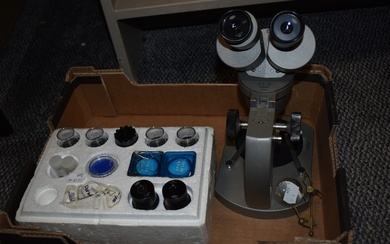 A vintage Olympus VT-11 microscope with lenses and specimen holders sold along with a watch makers