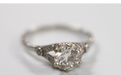 A white metal (stamped plat) and single stone diamond ring, ...