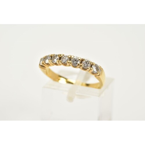 AN 18CT GOLD DIAMOND HALF ETERNITY RING, designed with seven...