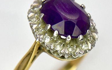 An 18K Yellow Gold Amethyst and Diamond Ring. Central...