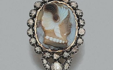 An 18th century diamond, agate cameo, 18K yellow gold and silver brooch The three-layer cameo on agate shows the profile of a man...