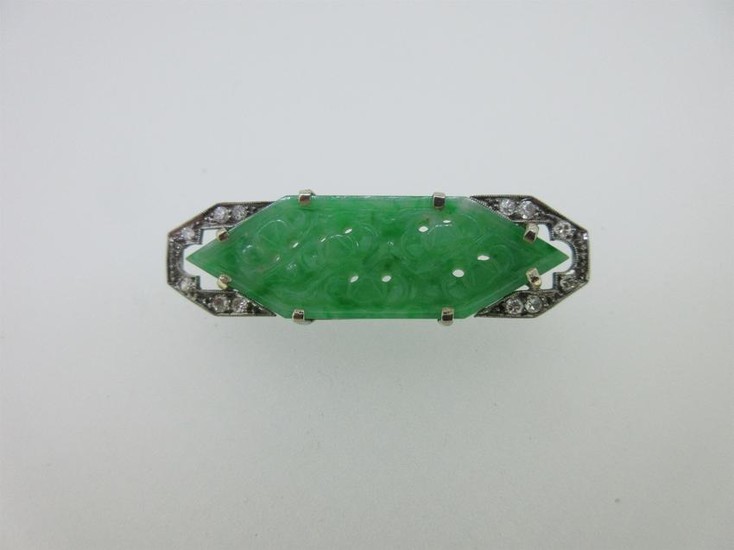 An Art Deco carved jade plaque and diamond brooch