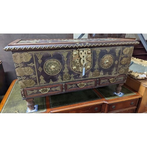 An Eastern brass mounted and studded hardwood trunk, length ...