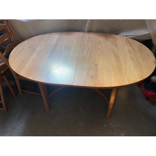 An Ercol extending dining table and six chairs.