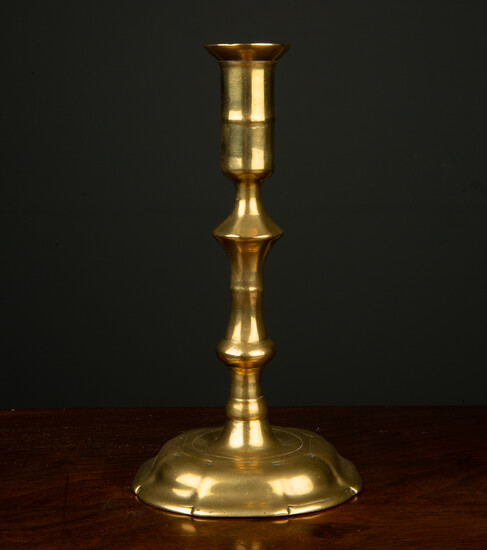 An early 18th century English brass candlestick