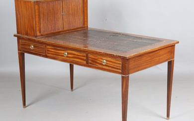 An early 20th century French mahogany and brass mounted bureau plat with raised tambour compartment