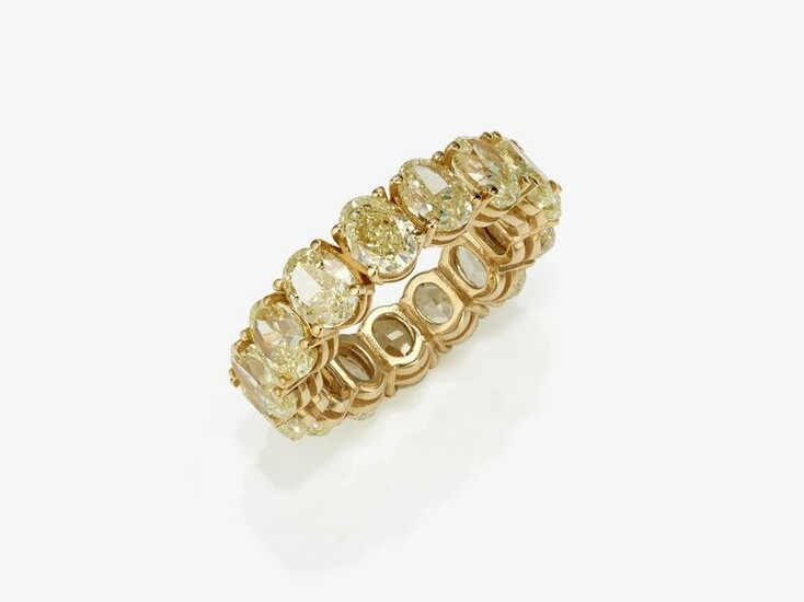 An eternity band ring decorated with oval diamonds in